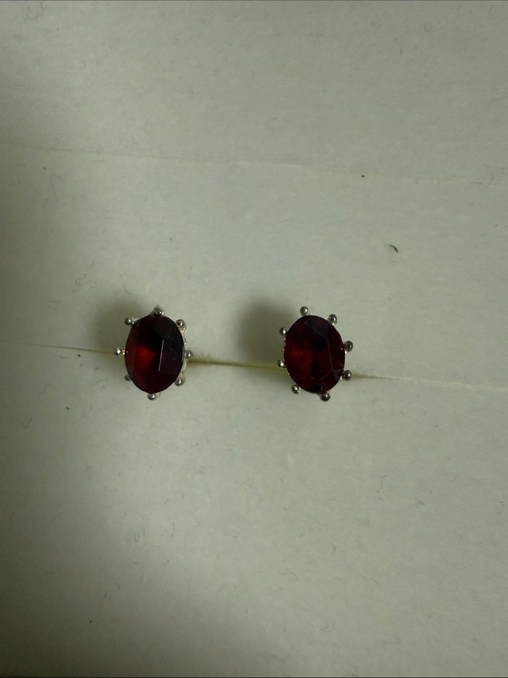 Ruby red oval rhinestone small dainty earrings with silver tone metal